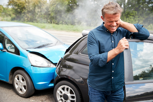 Man Holding his neck in pain after car accient