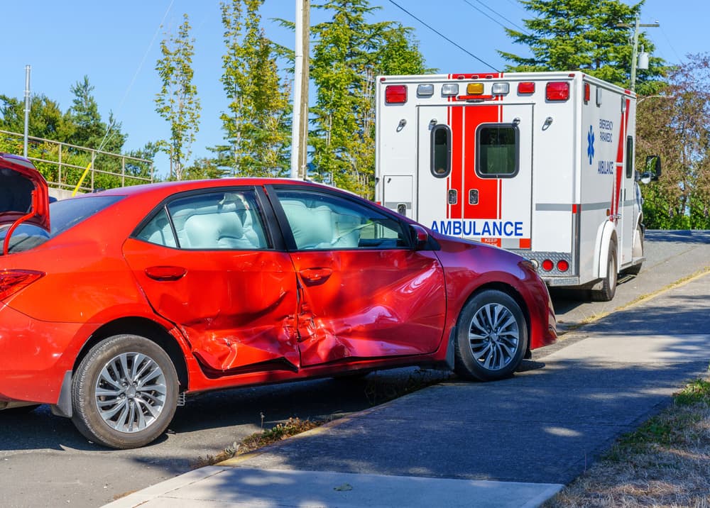 crashed car behind ambulance