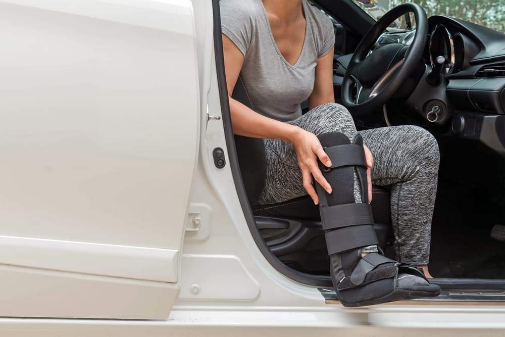 Injured woman using ortho fracture boot
