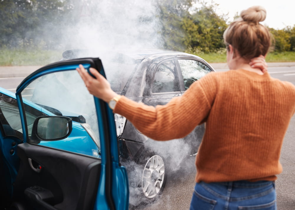 Woman holds her neck after a car accident