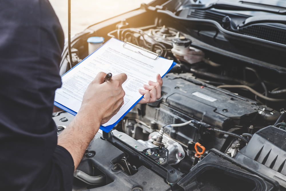 Mechanic checking a car engine