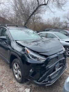 front end damage to black SUV after car crash
