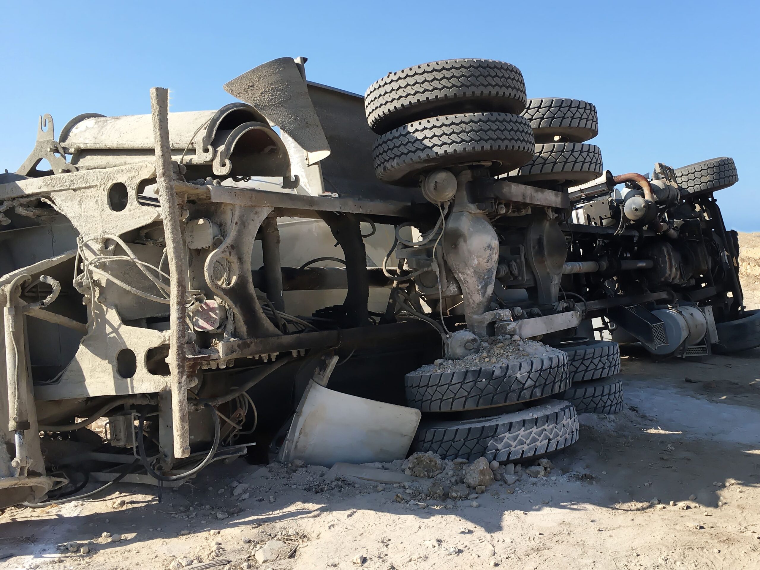 Concrete mixer truck overturned on the road after an accident