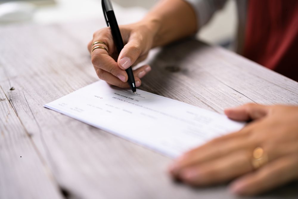 Man signing a settlement check