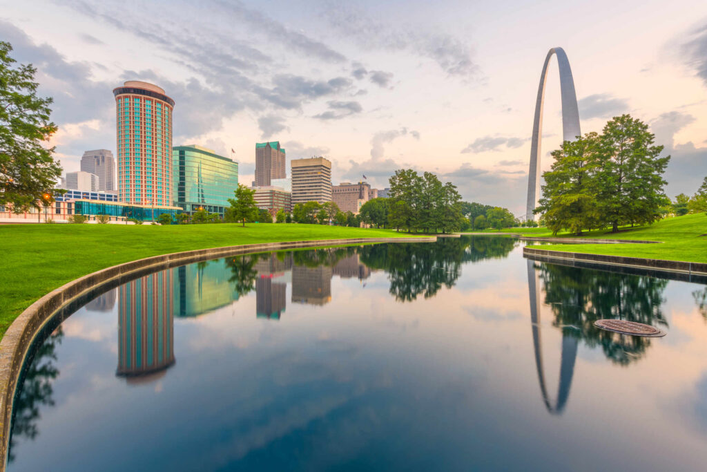St. Louis skyline and Gateway Arch reflecting in water served by St. Louis car accident lawyers.