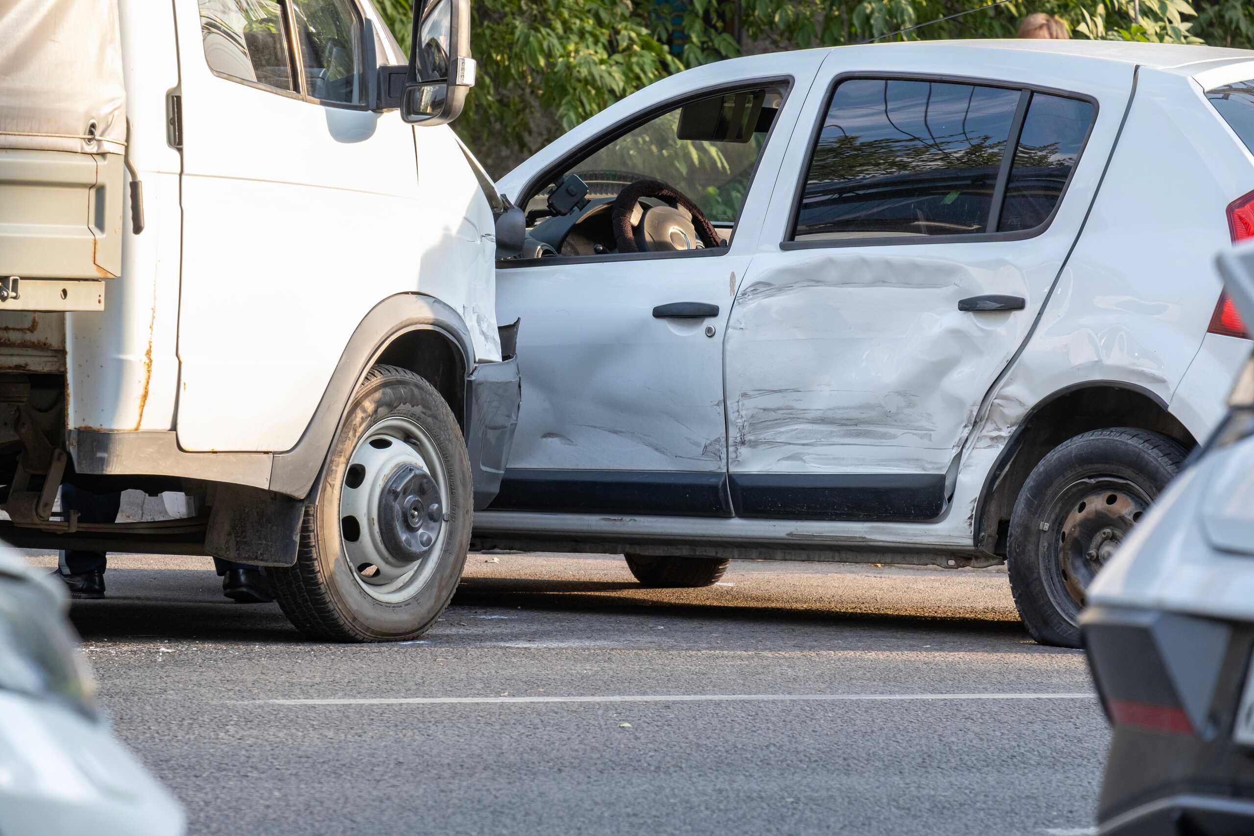 White delivery van colliding with a sedan represented by St. Louis Commercial Vehicle Accident Lawyers.