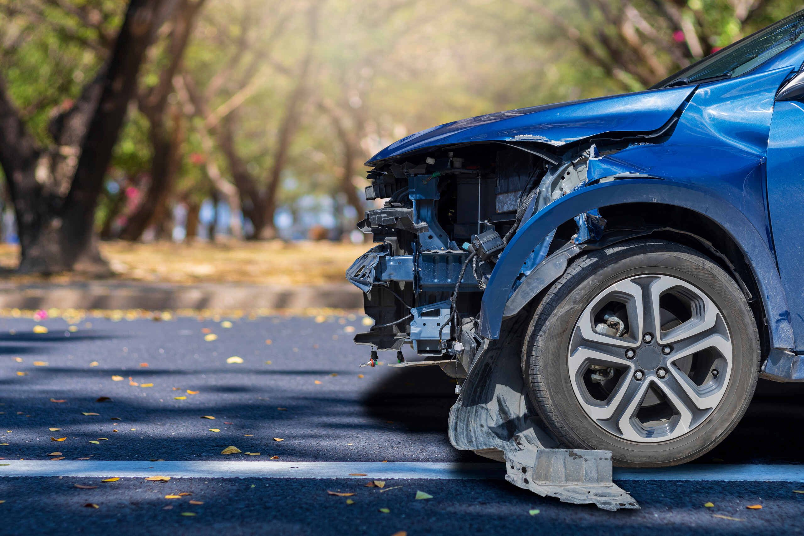 Damaged blue car front bumper following a crash handled by St. Louis Hit and Run Accident Lawyers.