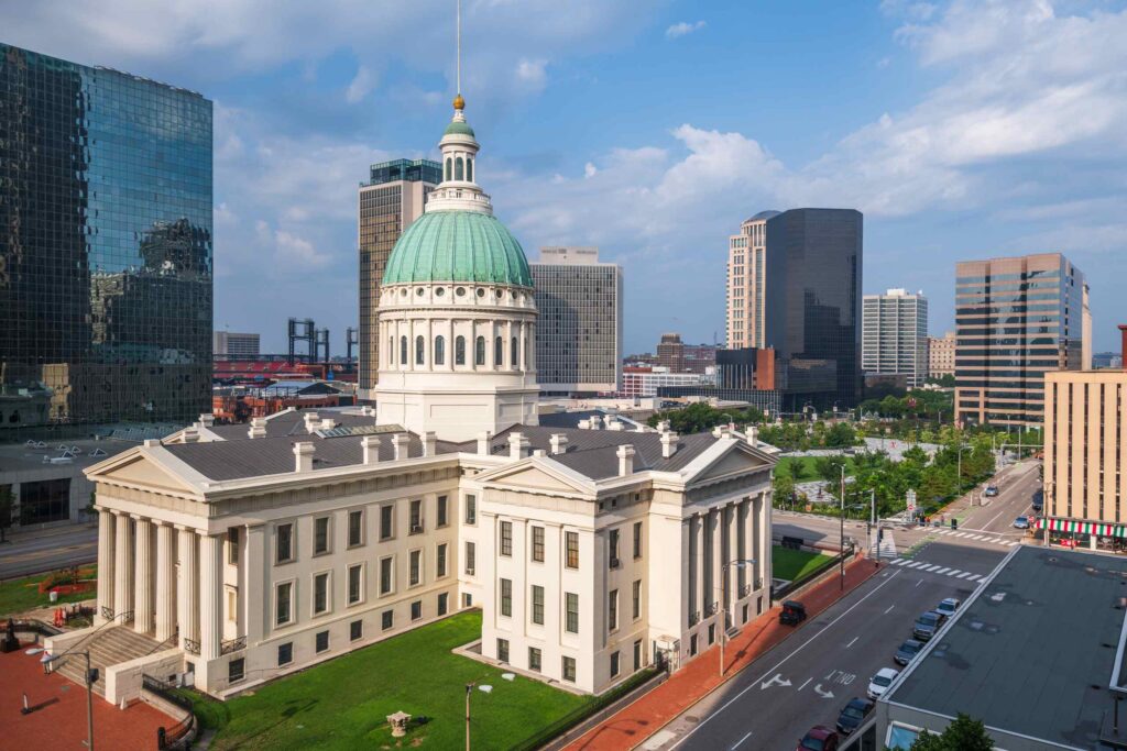An aerial view of downtown city streets and buildings representing St Louis parking lot accident lawyers.